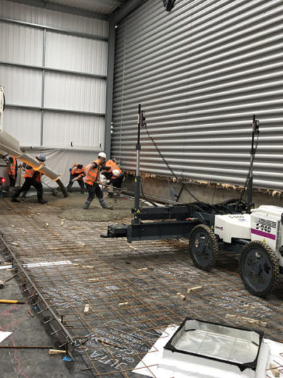 Industrial concrete flooring contractors using Somero laser screed on a new warehouse floor in Hounslow, London