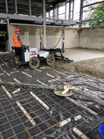 Somero laser screed in operation laying a new cast insitu warehouse concrete floor slab in Dagenham, East London.