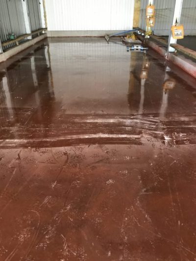 Sika Syntop red dry shake concrete floor slab completed with Sika Proseal curing agent. The Level Best Concrete Flooring concrete finishing and powerfloat team have achieved an excellently uniform coloured concrete floor slab.