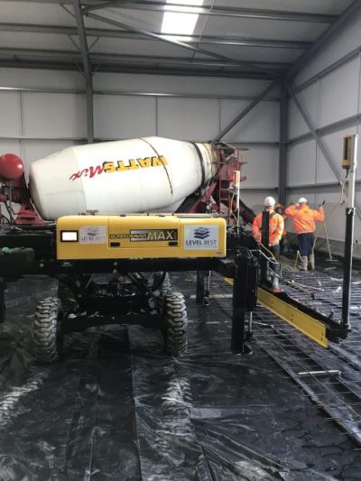 Laser screed concrete floor laying machine working in a new warehouse near Goole.